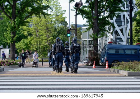 SHINJUKU, TOKYO - APRIL 29: Riot police on duty in Shinjuku on April 29, 2013. About 4,000 riot police persons are on duty in Tokyo. 40 % of Japan\'s riot squads serves in the capital.