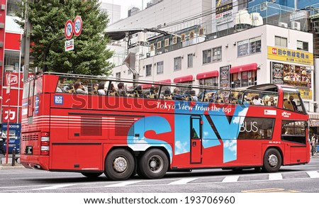 AKIHABARA, TOKYO - MAY 12: Sky Bus Tokyo running on the Chuo Dori Street, operated by Hinomaru Jidosha Kogyo, a tourist bus operator on May 12, 2014. The first open top tourist bus in Japan.