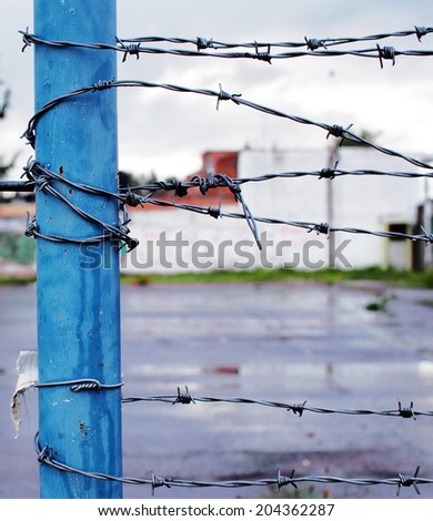 Background image of barbed wire or barbwire and wet ground, can be used for expressing loneliness, despair, gloomy, hopelessness, etc.