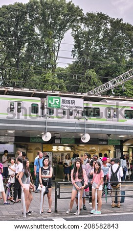 HARAJUKU, TOKYO - JUNE 29, 2014: JR (Japan East Railway Company) Harajuku Station, photographed from the entrance of Takeshita Street which is a pedestrian street with many fashion boutiques.