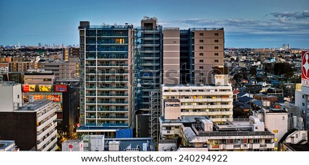 CHOFU, TOKYO - DECEMBER 7, 2014: Central area of Chofu City, western part of Tokyo. Commercial and residential buildings stand side by side, it is a typical urban development style of Japanese town.