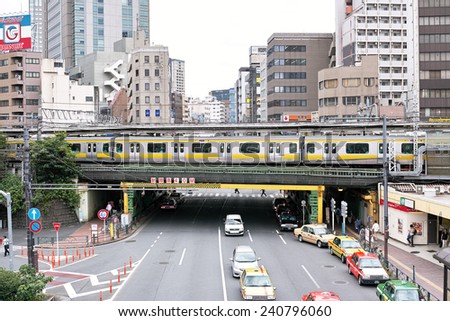 IIDABASHI, TOKYO - SEPTEMBER 4, 2014: Sobu Line train of JR (Japan Railway Company), Iidabashi station, road and taxies in Chiyoda Ward, Tokyo, Japan.