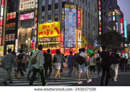 SHINJUKU, TOKYO - MAY 31, 2014: Crowd of people in Shinjuku, downtown Tokyo. About 800,000 people live and work here. The biggest commercial and night life town in Japan, called as sleepless city.