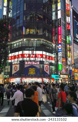 SHINJUKU, TOKYO - MAY 31, 2014: Crowd of people in Shinjuku, downtown Tokyo. About 800,000 people live and work here. The biggest commercial and night life town in Japan, called as sleepless city.