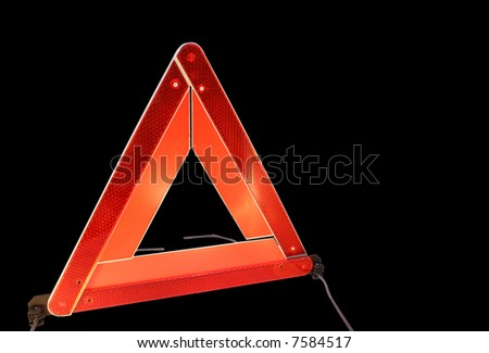 Road hazard warning triangle isolated on a black background