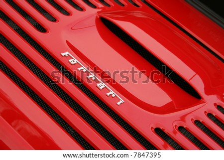 stock photo Chrome Ferrari badge on a bright red 355 engine cover