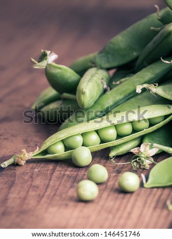 fresh Pea pods and Pea on a wooden Table