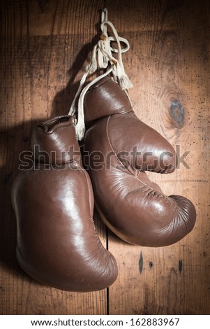 old Boxing Gloves hanging on wooden wall