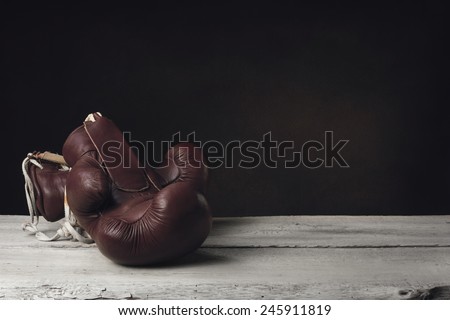 Boxing Gloves lying on two wooden Planks