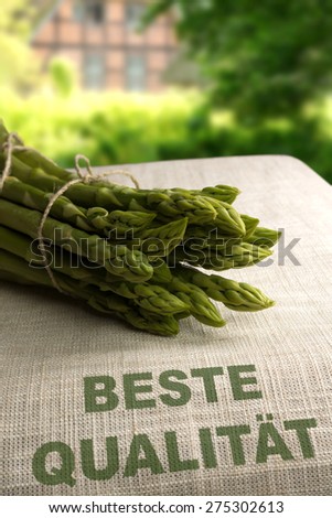 Green asparagus on bag with text \