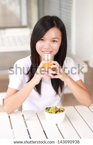 young lady eating healthy food at a restaurant