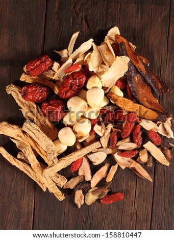 Traditional chinese dried herbal medicine on brown color wooden background