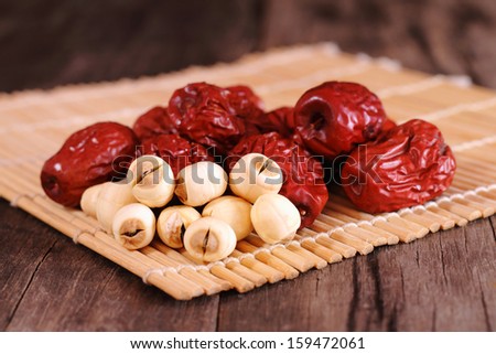 Dried chinese jujubes fruits and lotus seeds on bamboo mat