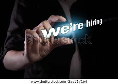 Hand showing we\'re hiring text on the virtual screen