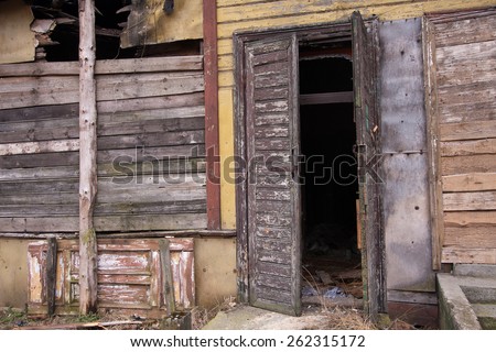 An old dilapidated wooden door open