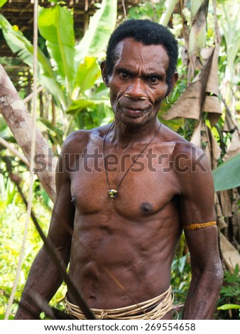 The jungle, Indonesia - January 14, 2015: A man from the  Korowaya tribe met when hiking through the jungle