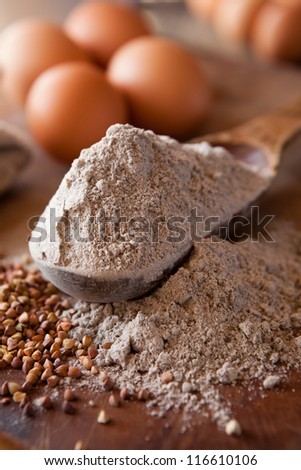 Buckwheat flour in a wooden measuring spoon