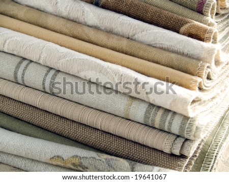 Natural color fabric swatches with plain, striped and floral patterns