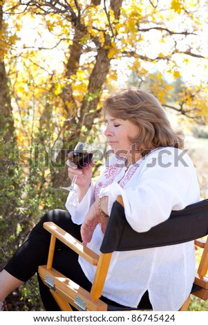 Woman enjoying her red wine, taking the first sniff.
