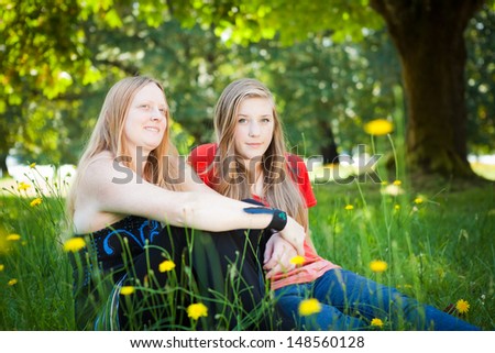 Mother and daughter in green summer nature. Shallow DOF, girl\'s face in focus.
