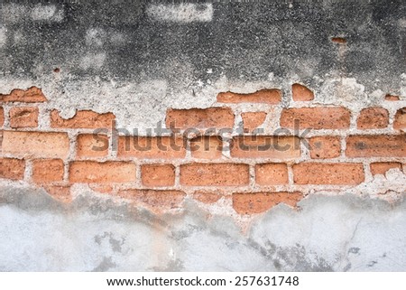 Texture of cracked concrete showing brick wall inside