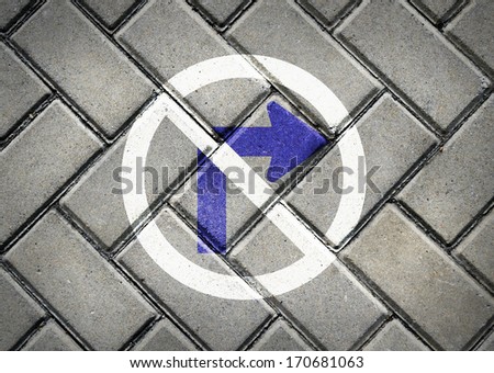 No Turn right direction sign on patterned pavement