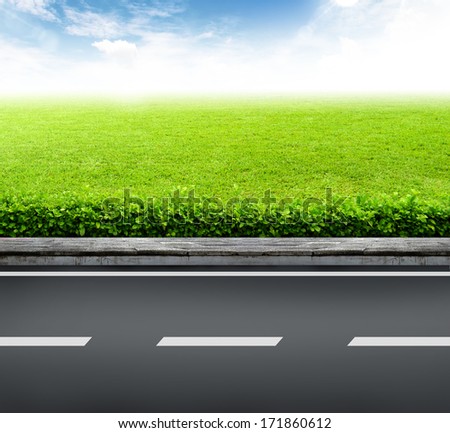 Roadside view and green grass on blue sky