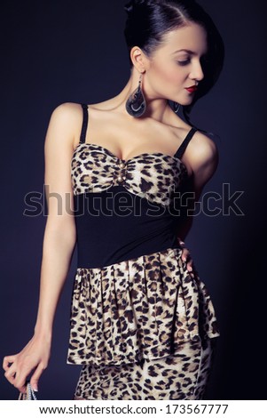 Glamorous young woman in a leopard print dress