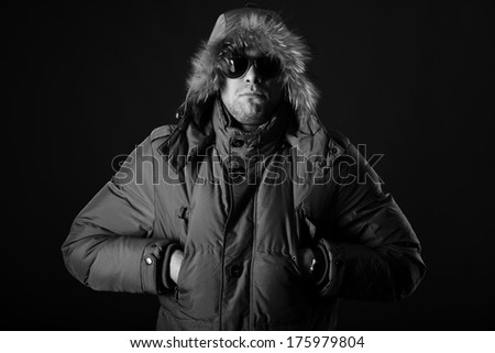 Portrait of brutal man in winter jacket