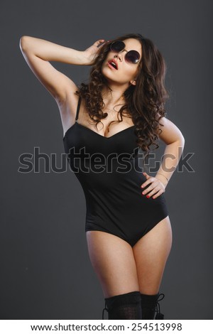 Sexy girl model looks in black body dark background