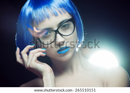 Portrait of a girl with bright makeup and colorful hair