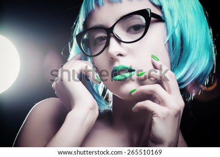 Portrait of a girl with bright makeup and colorful hair