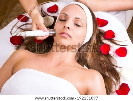 Woman getting laser and ultrasound face treatment in medical spa center, skin rejuvenation concept
