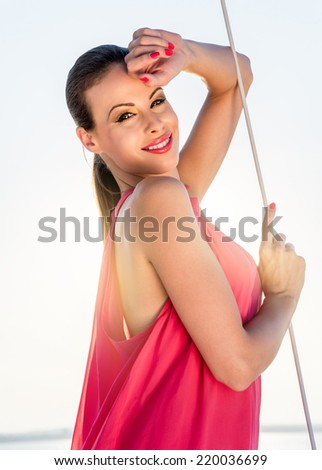 Portrait  of young beautiful woman on a boat at summer nature.