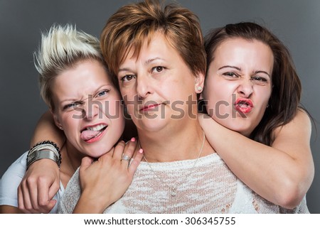 Funny family with mother and daughters. Studio shot.