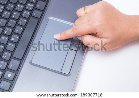 Woman finger touch on laptop