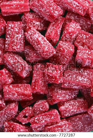 A pile of sour red licorice candy.
