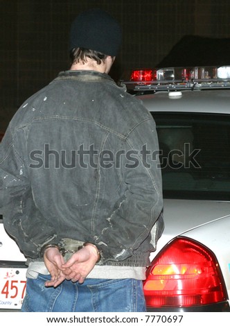 A young man is handcuffed by police in Edmonton,Alberta,Canada.