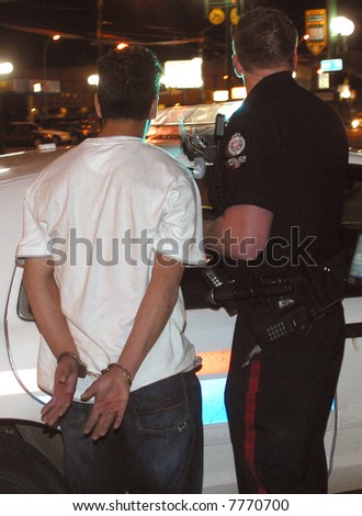 A young man is arrested by police in Edmonton,Alberta,Canada.