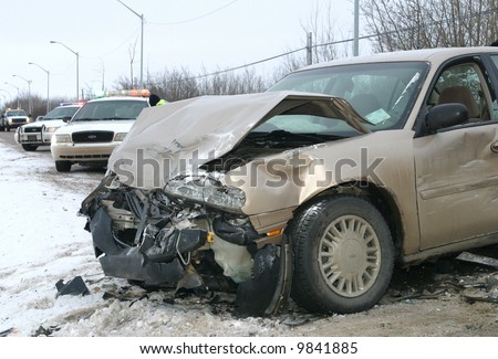 police investigate a car accident on an icy road.