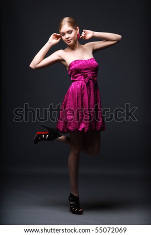 stock photo : Beautiful young woman wearing pink dress and black high heels 