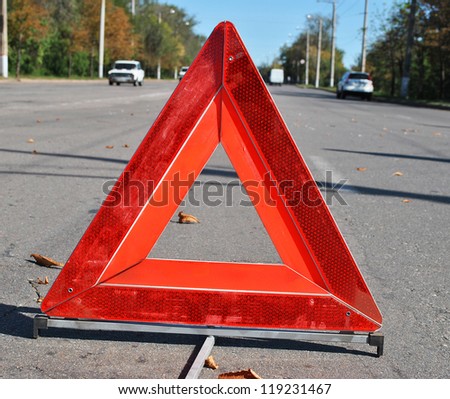 Warning sign in the middle of the road at accident time
