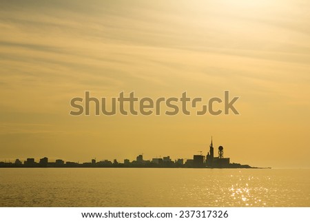 silhouette of modern city in the gold sunset