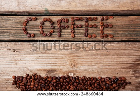 the coffee beans and coffee cup on wooden background