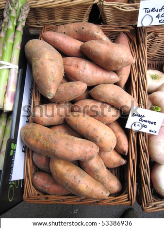 Red sweet potatoes pouring in a woven basket