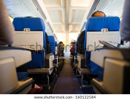 Passengers inside the cabin of a commercial airliner during flight