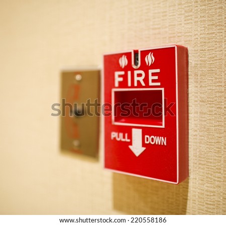 Red fire alarm box on the wall