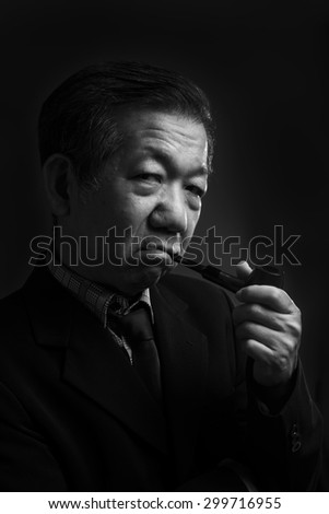 Portrait of a senior man smoking a pipe