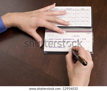 Woman writing check for auto loan