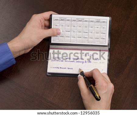 Woman writing check to credit card company